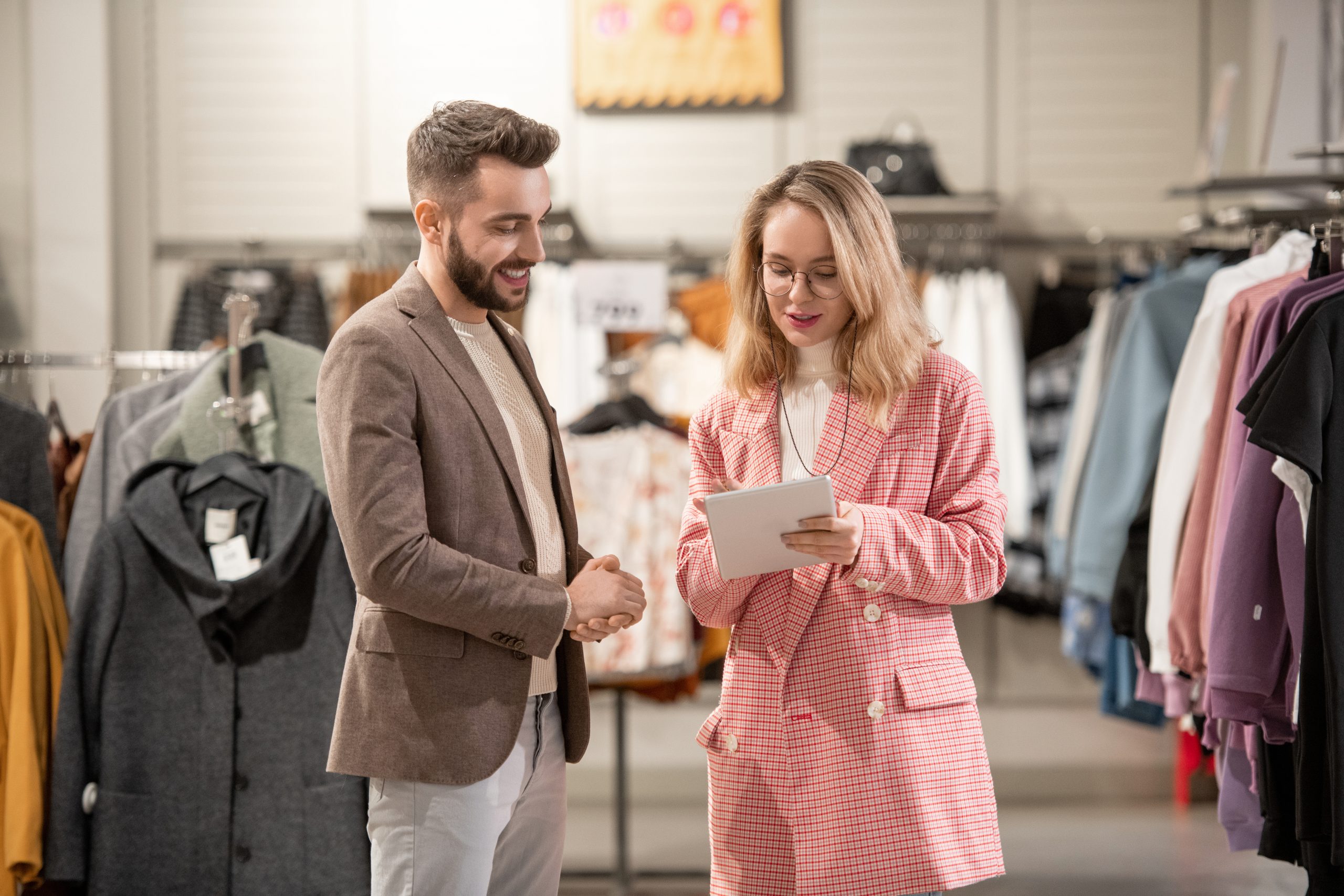 A man and a woman talking in a clothing store
