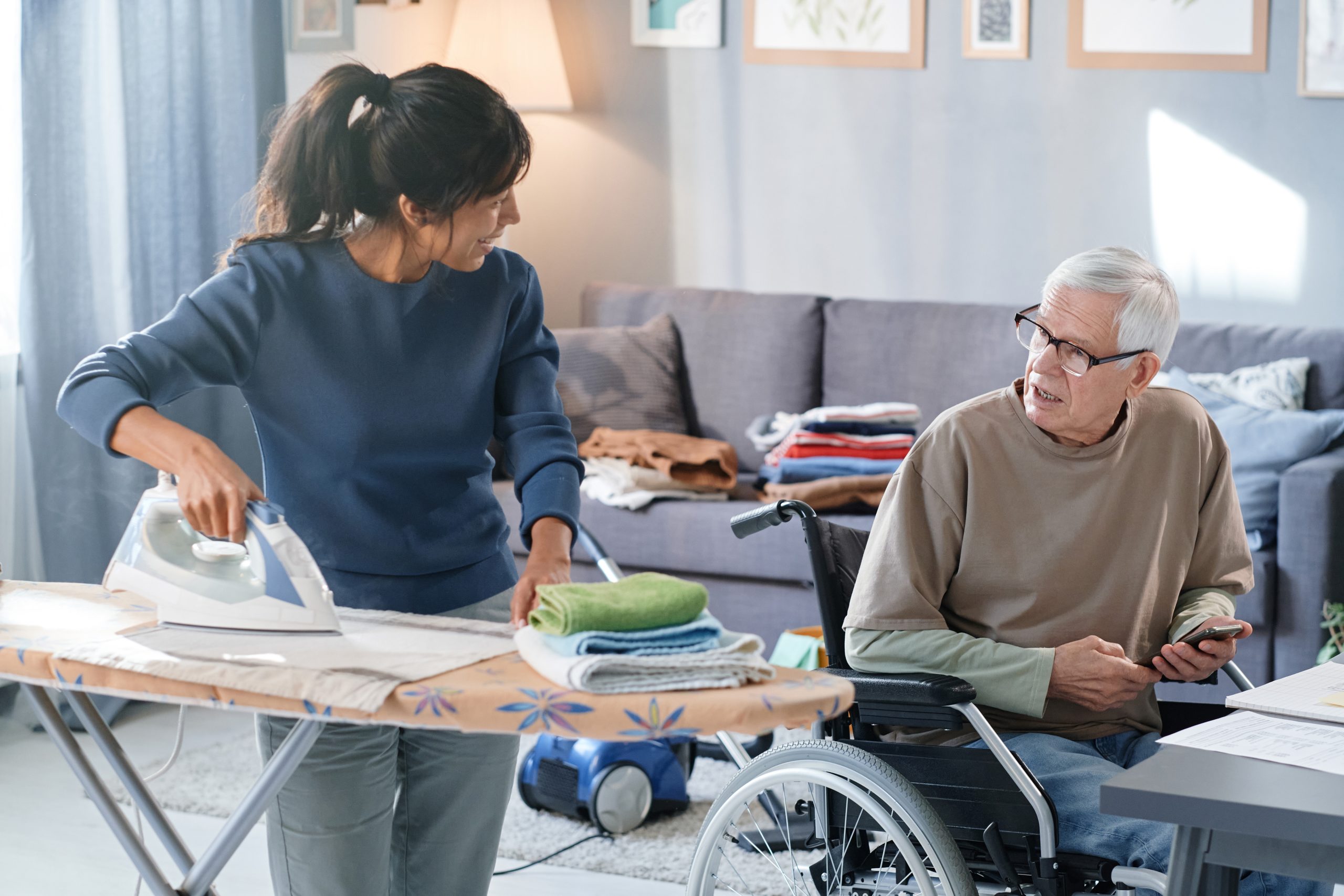 Volunteer helping to senior man with chores