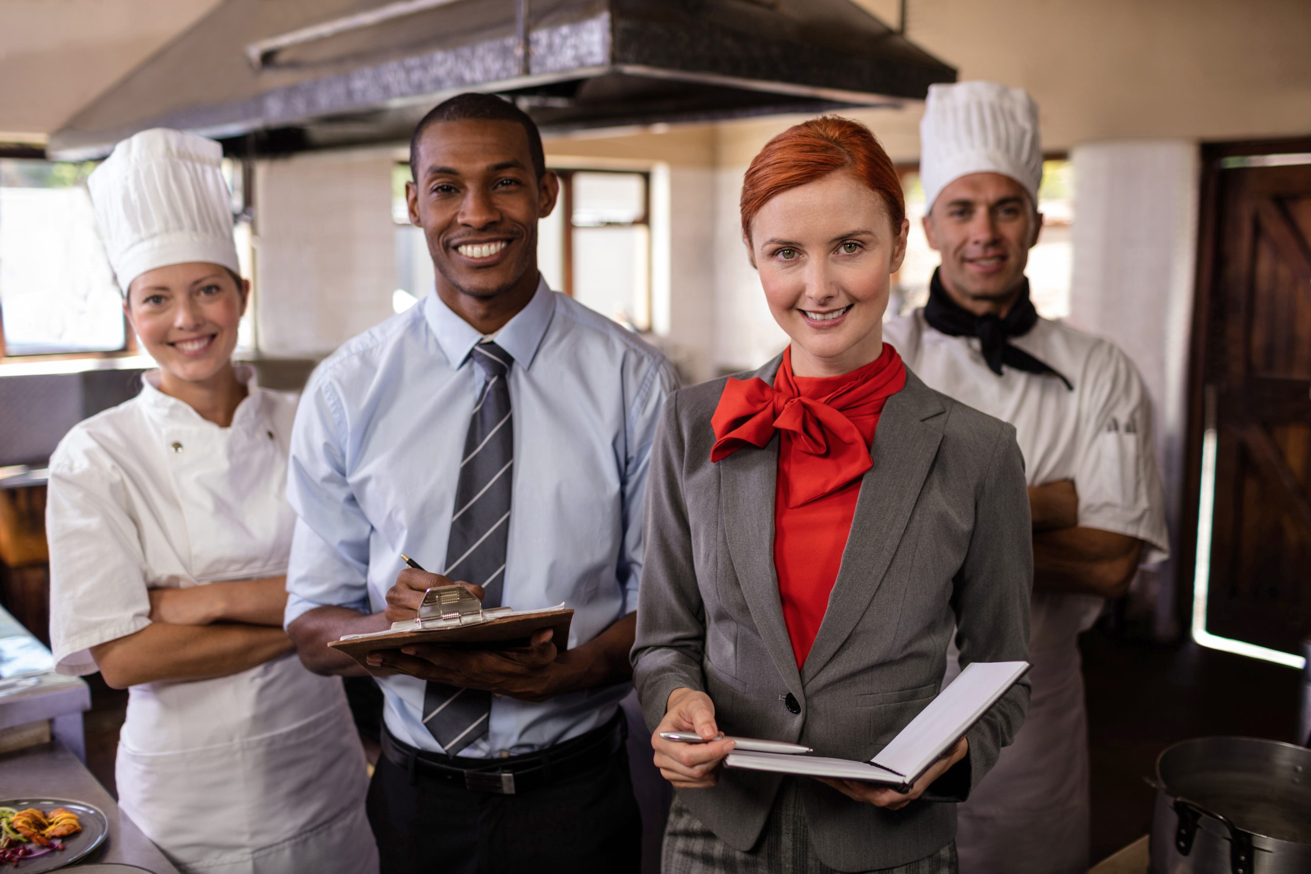 Group of hotel staffs standing in kitchen at hotel